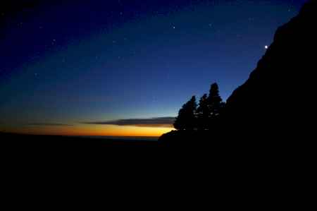 Dark Night and first stars split by Spike of vivid Sunset Colors